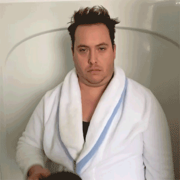 gif of tired man in bathrobe pouring huge mug of coffee on himself