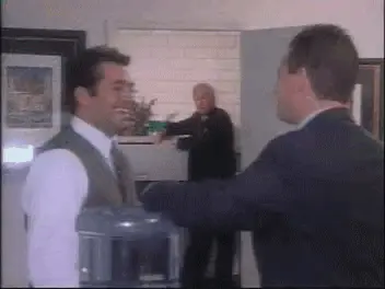 gif of man laughing watching two coworkers talking