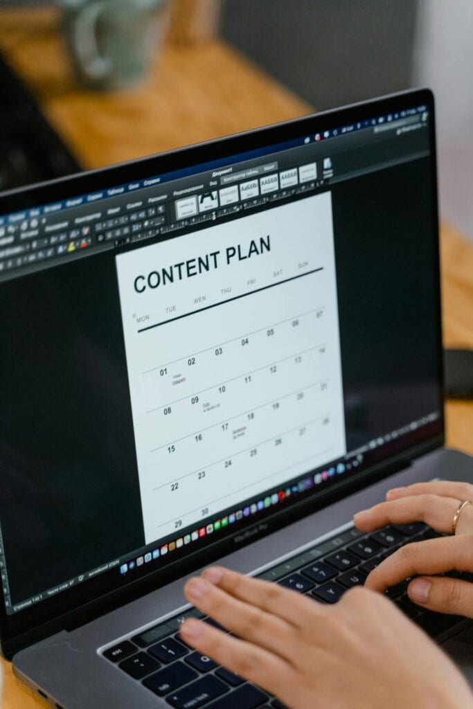 Person working on content plan on laptop