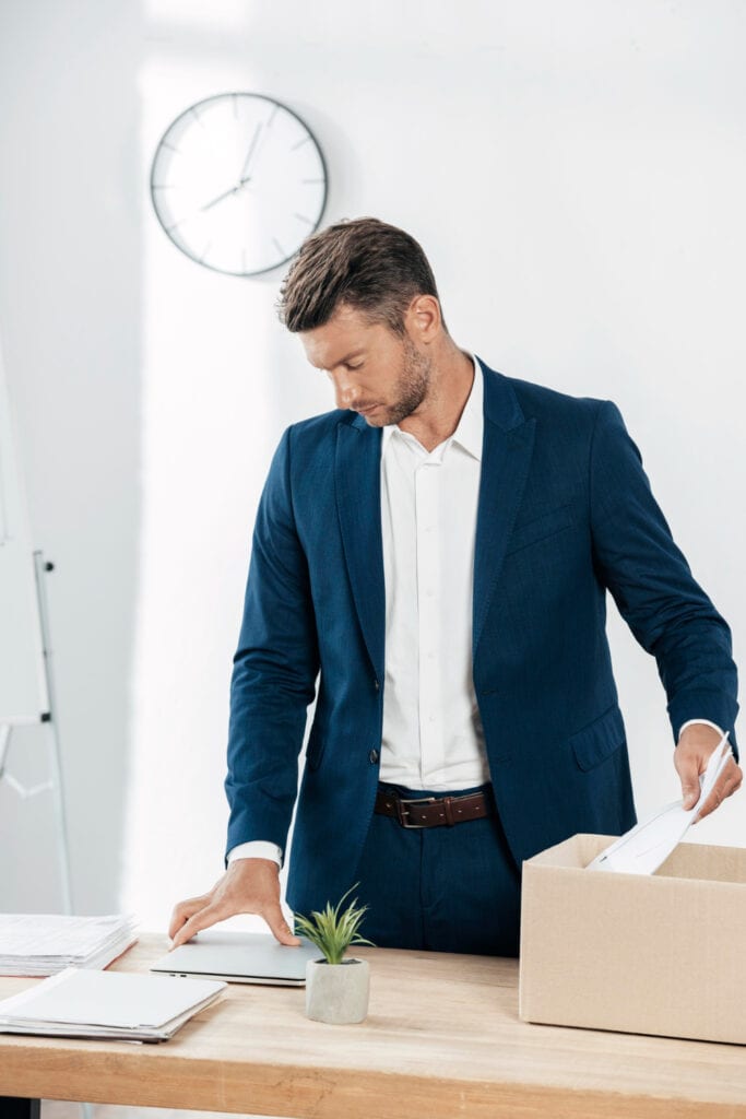 Executive relocation expert unpacking office supplies on a desk