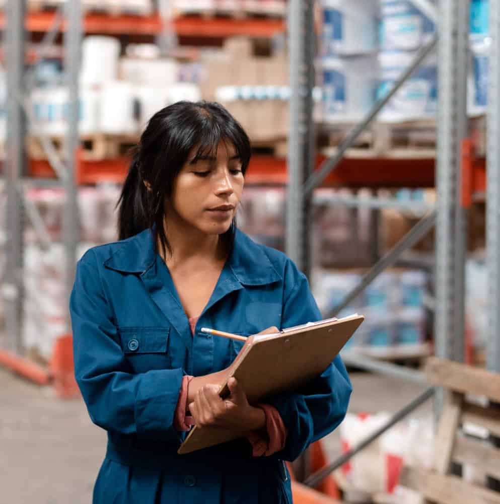 Retail supply chain consultant taking notes in a warehouse
