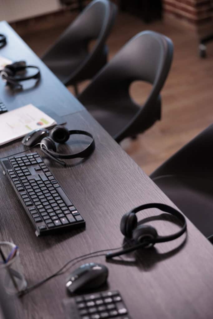 Empty helpdesk office with headphones laid on the table.