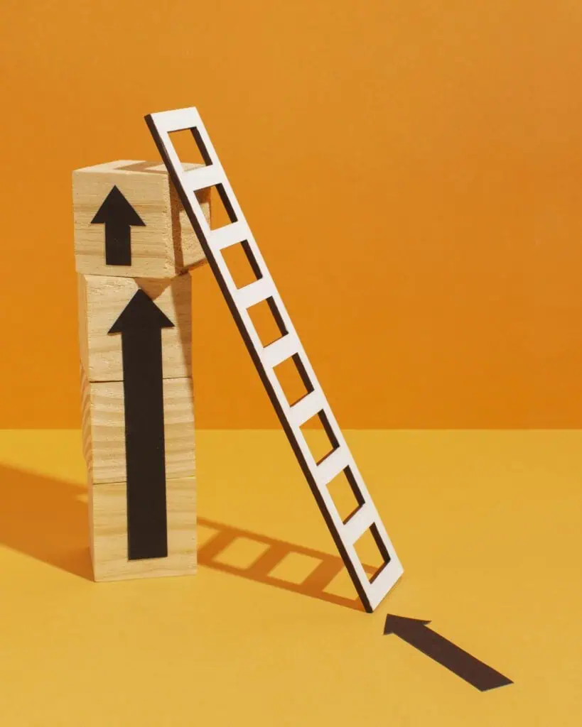 Ladder with wooden cubes symbolizing continuous improvement