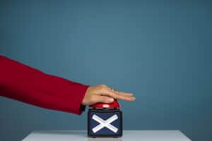 Side view of hand pressing X button