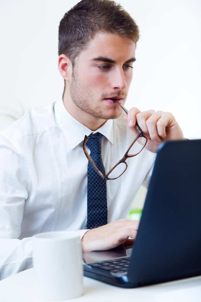Young man working in his office with laptop