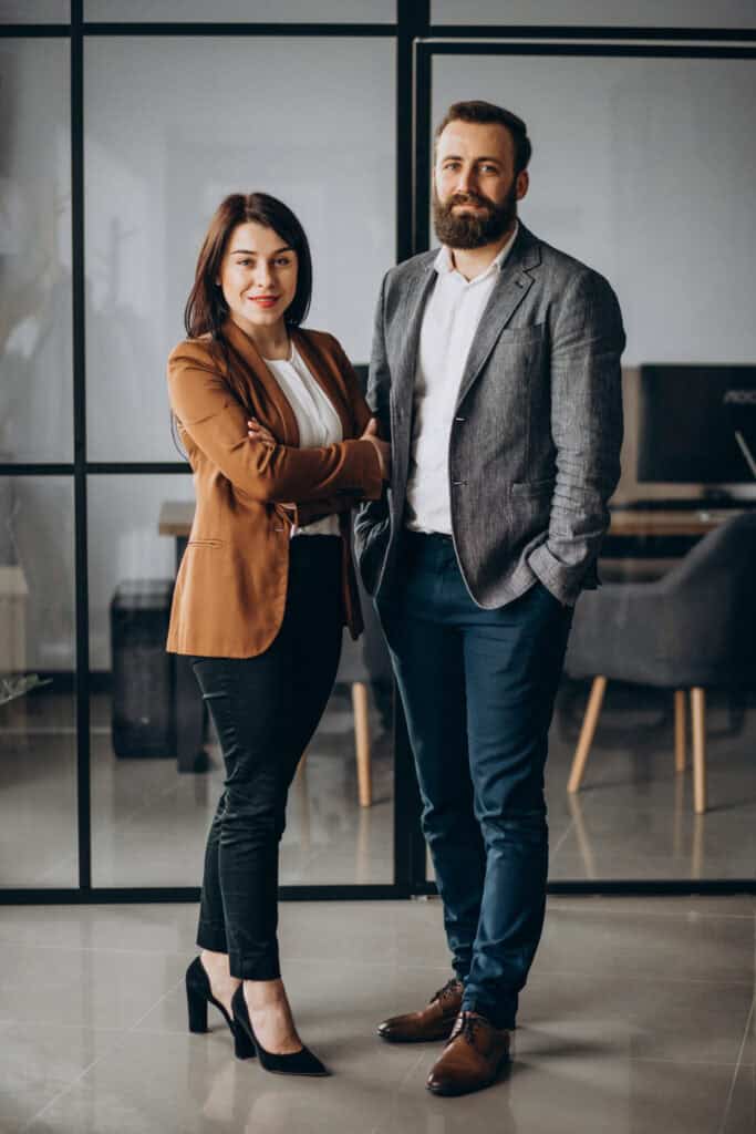 Business partners, woman and man, standing in office