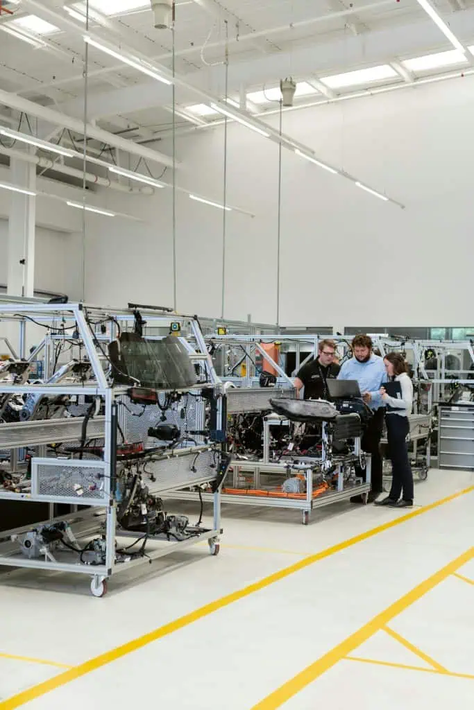 Three automation engineers working on a machine