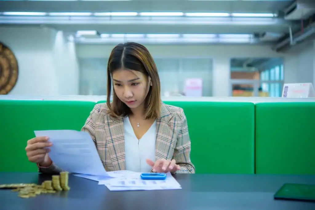 Cost reduction services expert working in an office, calculating costs