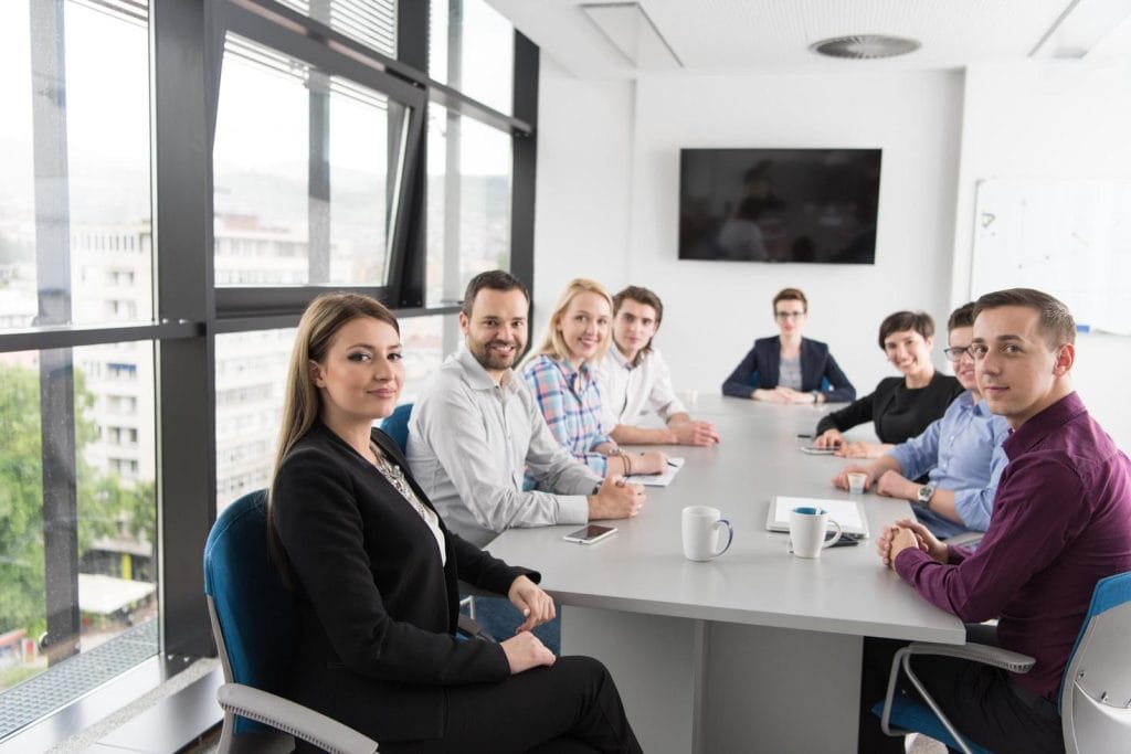 Group of interim marketing specialist having a meeting in well lit modern office room